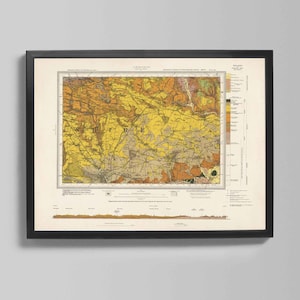 May include: Framed vintage map print with a black frame. The map features a detailed geological survey with a color palette of yellow, orange, and brown. The map is mounted on a cream-colored background.