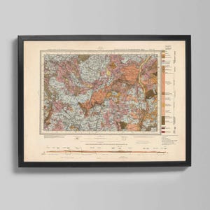 Puede incluir: Mapa geológico vintage enmarcado con marco negro. El mapa presenta una ilustración detallada con varios colores, incluyendo rosa, marrón y amarillo, que representan características geográficas. El mapa incluye texto y una clave en el lado derecho.