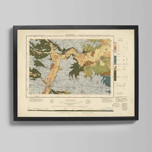 May include: Framed vintage map print with a black frame. The map features a detailed geological survey with various colors representing different land features. The map is mounted on a cream-colored background.