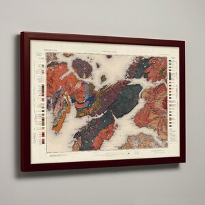May include: A framed vintage map of a geological region, featuring a colourful, detailed illustration of different rock formations and land masses. The map is surrounded by a dark red wooden frame.