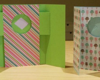 May include: Two green and white card designs. The first card has a striped pattern with a circle cut out. The second card has a pattern of ice cream cones with different colored scoops.