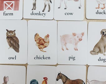 May include: A set of 10 illustrated flashcards featuring farm animals, including a cow, pig, chicken, rooster, horse, donkey, goat, duck, owl, and rabbit. Each card has a watercolor illustration of the animal and the animal's name printed below.