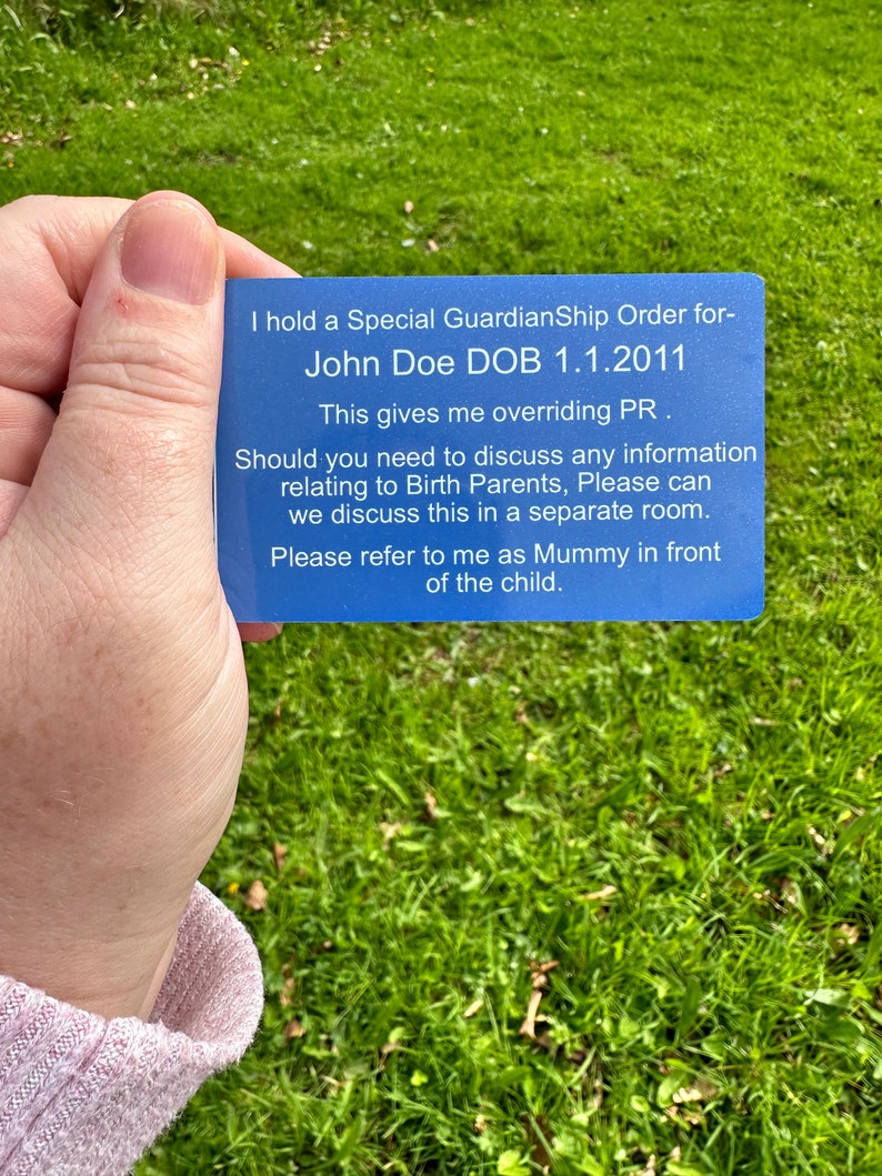 a person holding a blue business card in their hand