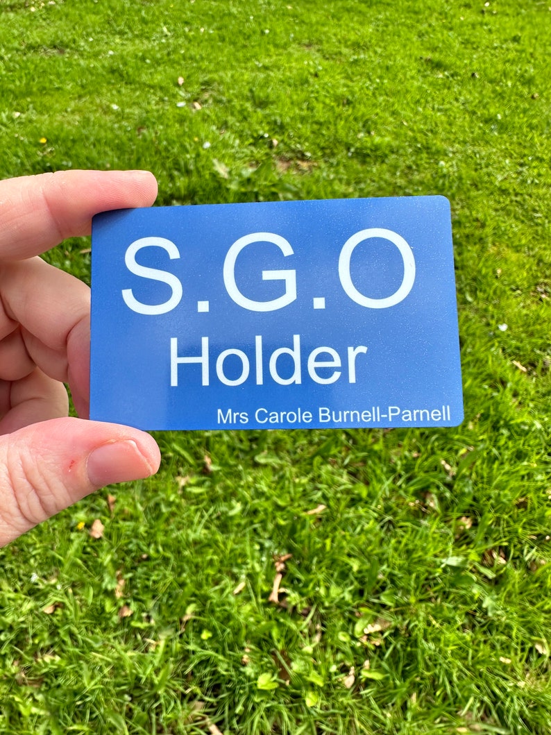 a person holding up a blue business card