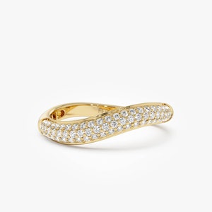 May include: A gold band ring with a wave-like design, set with small diamonds.