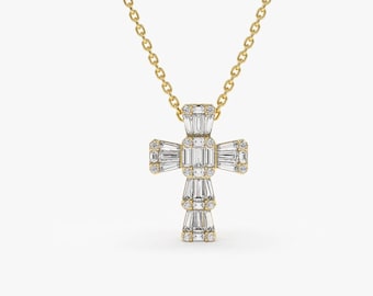 May include: A gold chain necklace with a small, diamond-encrusted cross pendant.
