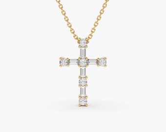 May include: A gold chain necklace with a small diamond cross pendant. The cross is set with baguette and round diamonds.