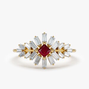 May include: A gold ring featuring a red square gemstone surrounded by smaller white baguette diamonds.