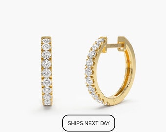 May include: A pair of gold hoop earrings with a row of small diamonds around the edge.