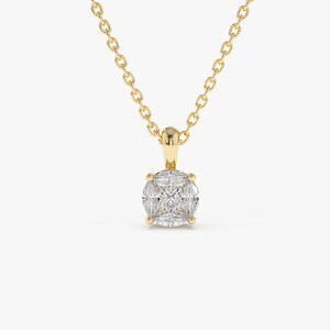 May include: A gold chain necklace with a round pendant featuring a cluster of small, clear diamonds.