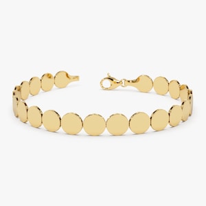 Könnte beinhalten: Ein goldenes Armband mit einer Kette aus runden, flachen Gliedern.