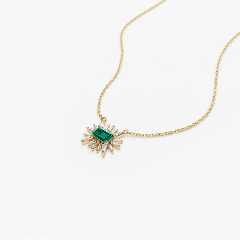 14k Tapered Baguette Diamond necklace with an Emerald Laying Flat View