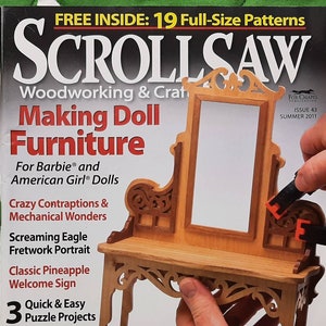 May include: A magazine cover for Scroll Saw Woodworking & Craft magazine, issue 43, Summer 2011. The cover features a doll-sized wooden furniture set with a mirror and a table. The magazine cover text reads "Making Doll Furniture" and "For Barbie® and American Girl® Dolls".
