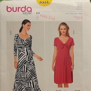 May include: A Burda Style dressmaking pattern, featuring two dress designs. One dress is a long, black and white geometric print, and the other is a solid red dress. The pattern includes sizes US 8-20.