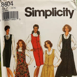 May include: Simplicity sewing pattern 8604 showing dress designs. The pattern envelope features illustrations of dresses in black, red, floral, and yellow. The size is P (12-16). The brand name "Simplicity" is clearly visible.