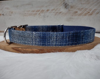 May include: A blue and white plaid dog collar with a silver buckle.