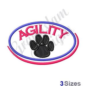 May include: An embroidered design of a paw print inside a pink and blue oval with the word "AGILITY" in pink letters.