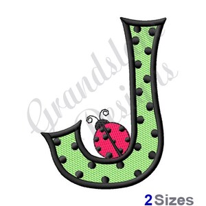 May include: Green letter J with black polka dots and a red ladybug with black spots on it.
