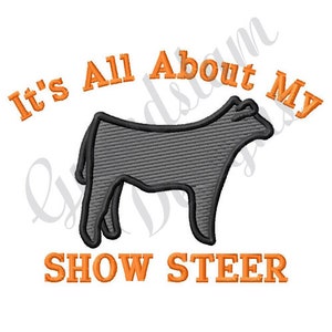 May include: It's All About My Show Steer embroidery design featuring a gray silhouette of a steer with orange text.
