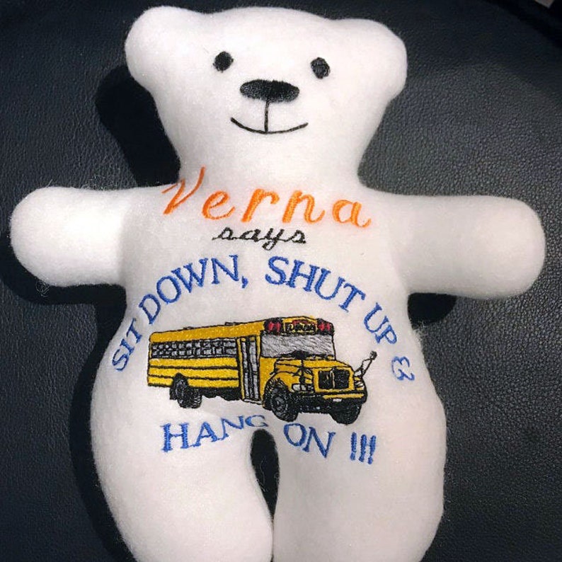 May include: White plush teddy bear with embroidered text that says "Verna says Sit Down, Shut Up & Hang On!!!" and a yellow school bus graphic.