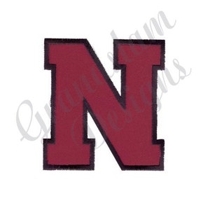 May include: A large, red felt letter N with a black outline. The letter is in a bold, blocky font.