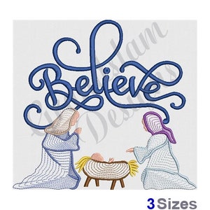 May include: An embroidered design featuring the word "Believe" in blue script above a nativity scene. The scene includes two figures kneeling, with a baby in a manger. The design is on a white background.