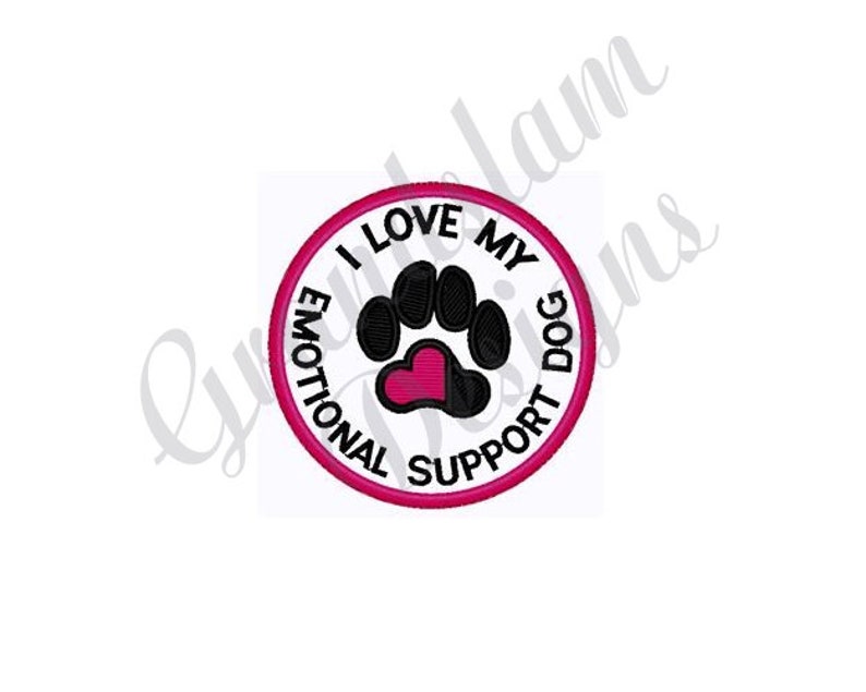 May include: A white circle with a pink border and the text "I Love My Emotional Support Dog" in black. A black paw print with a pink heart in the center is inside the circle.