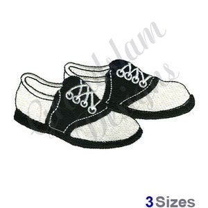 May include: A pair of black and white saddle shoes with laces. The shoes are embroidered and have a classic design.