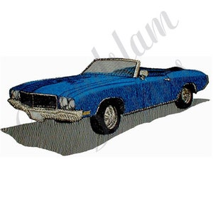 May include: A blue convertible car with a white interior. The car is a classic model with a long hood and a short trunk. The car is sitting on a gray surface.
