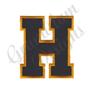 May include: A black felt letter H with a gold outline. The letter is in a varsity style font.