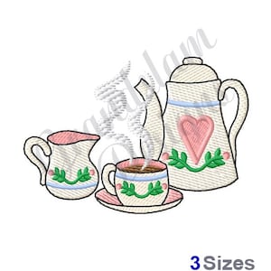 May include: A white teapot with a pink heart and green leaves design, a white creamer with a green leaf design, and a white teacup with a green leaf design and a saucer. The teacup has steam coming from it.