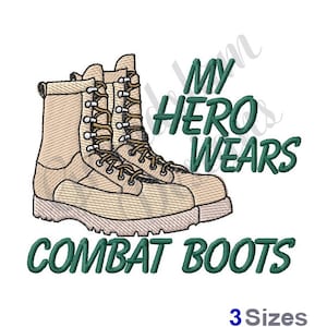 Puede incluir: Un diseño de bordado que presenta un par de botas de combate de color canela con el texto "My Hero Wears Combat Boots" en verde.