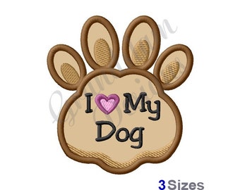 May include: Embroidered paw print design with the text "I Love My Dog" and a pink heart. The paw print is tan with brown accents and the text is in black. The image also includes the text "3 Sizes".