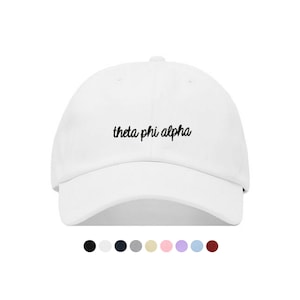 Puede incluir: Gorra de béisbol blanca con texto bordado en negro que dice "theta phi alpha".