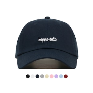May include: A navy blue baseball cap with white embroidered text that reads "kappa delta".