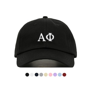 May include: Black baseball cap with white embroidered letters "AΦ" on the front.