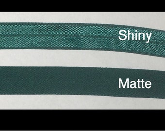 May include: Hunter Softband, 5/8 inch wide, for Ponto, Adhear, or Baha. The image shows two bands of dark green elastic, one shiny and one matte. The text "Shiny" and "Matte" are next to each band. The image also shows three different connectors.