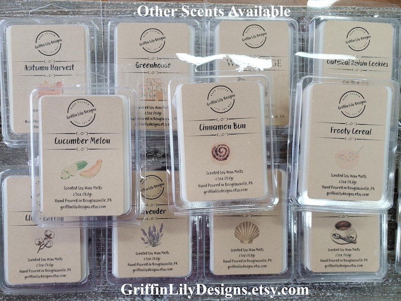 May include: A collection of 12 small, clear plastic containers filled with scented soy wax melts. Each container has a label with a different scent name and a small image. The scents include: Autumn Harvest, Greenhouse, W, Cinnamon Bun, Frooty Cereal, Cucumber Melon, Lavender, Sea Shell, Coffee, Oatmeal Raisin Cookies, and Lilac. The containers are arranged in a grid pattern on a wooden surface. The text "Griffin Lily Designs.etsy.com" is printed at the bottom of the image.
