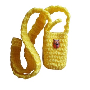 May include: A yellow crocheted bag with a long strap. The bag has a small owl button on the front.