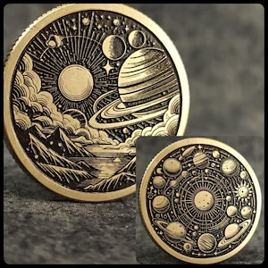 May include: Two gold-toned metal coins with intricate engraved designs depicting celestial bodies. One coin features a detailed image of a planet with rings, a moon, and stars, while the other coin shows a more abstract representation of a solar system with multiple planets and a sun.