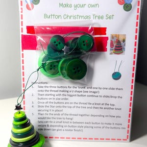 May include: A craft kit for making a button Christmas tree. The set contains green buttons, a star charm, and instructions. The packaging reads "Make your own Button Christmas Tree Set". The finished tree is made of layered green buttons.