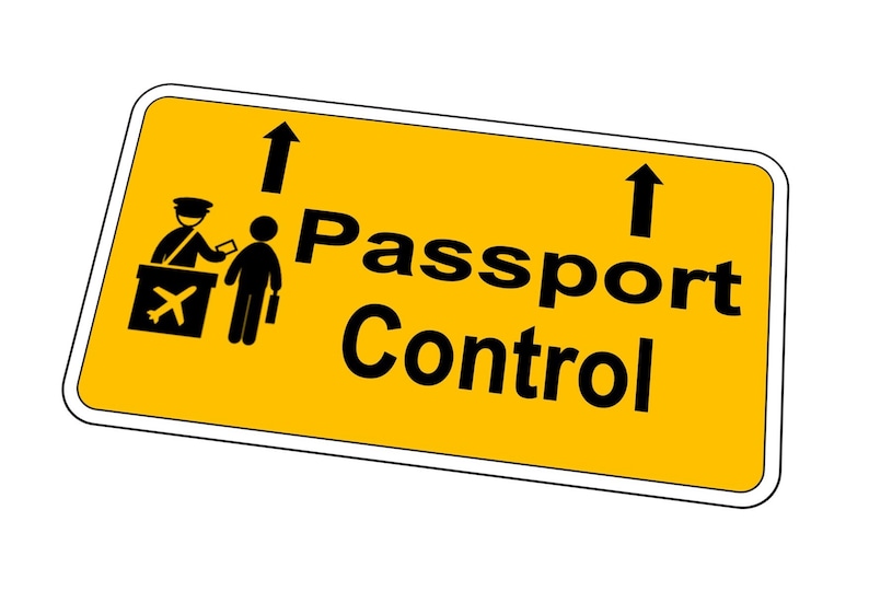 May include: Yellow sign with black text and arrows pointing upwards. The sign reads "Passport Control" and includes a black and white illustration of a person at a passport control desk.