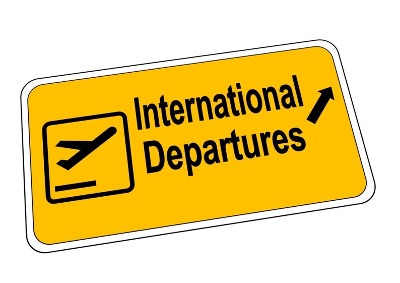 May include: Yellow sign with a white border and black text that reads "International Departures". A black airplane icon is in the top left corner of the sign. A black arrow points upwards.