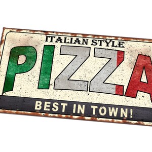 May include: A vintage-style metal sign with a rusty border, advertising "ITALIAN STYLE PIZZA BEST IN TOWN!" The word "PIZZA" is in large, colorful letters, with green, white, and red colors reminiscent of the Italian flag.