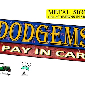 May include: A rectangular metal sign with the word "DODGEMS" in large yellow letters with a blue background and star accents. Below, it reads "PAY IN CAR" in white letters. The sign also includes the text "METAL SIGNS" and "100s of DESIGNS IN SIGNS".