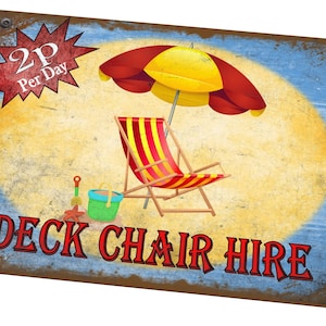 May include: A vintage-style sign advertising deck chair hire for £2 per day. The sign features a red and yellow striped deck chair, a red and yellow beach umbrella, and a bucket and spade on a sandy beach.