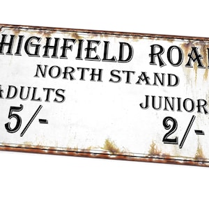 May include: A white metal sign with rusty edges, reading "Highfield Road North Stand Adults 5/- Juniors 2/-"
