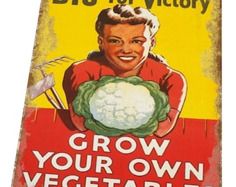May include: A vintage-style metal sign with a yellow background and red text. The sign features a woman holding a head of cauliflower and the text "DIG for Victory GROW YOUR OWN VEGETABLES".