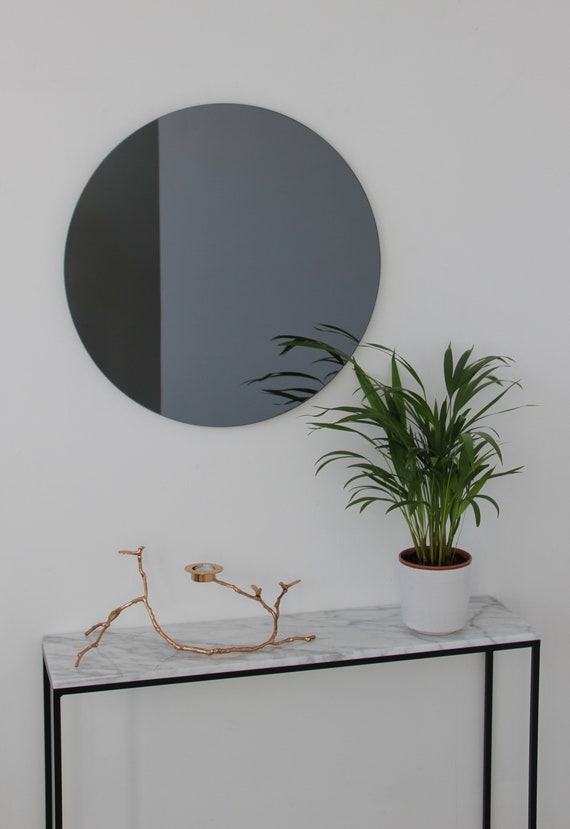 Black-and-white-entryway-with-large-round-custom-cut-mirror-design