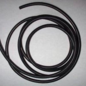 May include: A black rubber cord coiled up on a white surface.